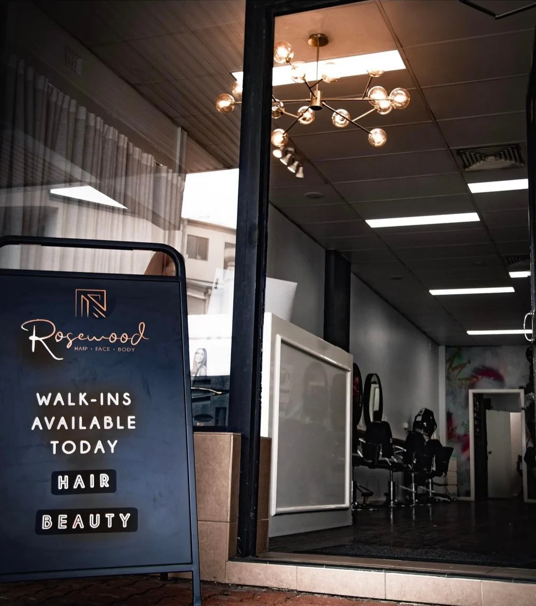 The Rosewood Hair Face Body shopfront on the Princes Highway at Woonona, with the walk-ins sign out the front
